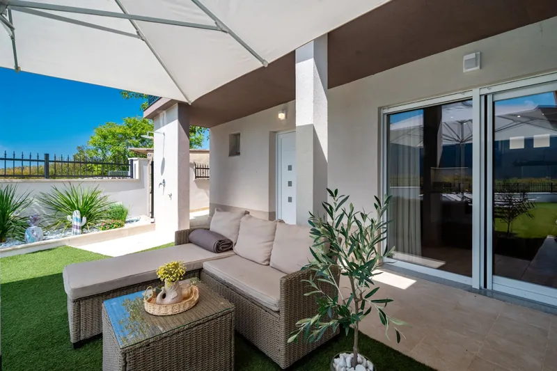 Shaded outdoor lounge beside the villa