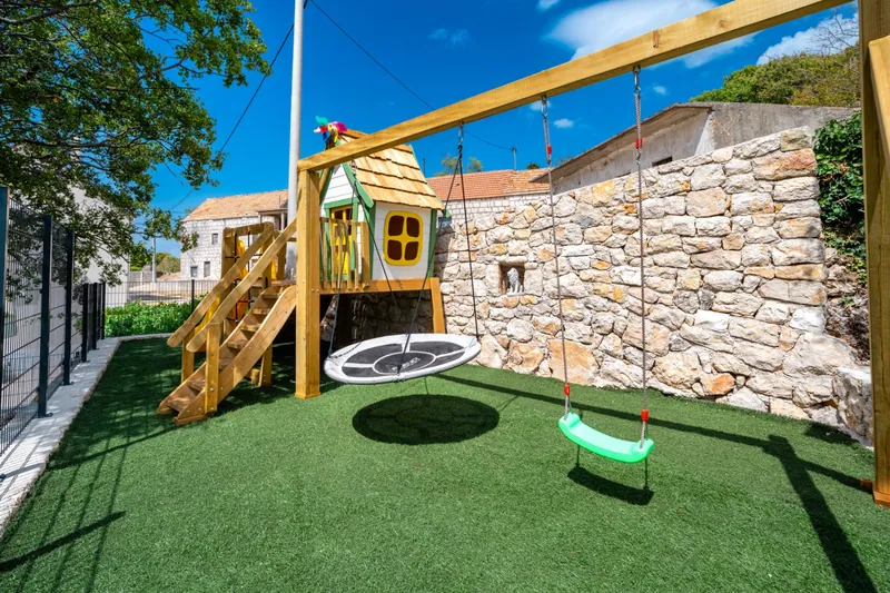 Children’s climbing house, slide and swings