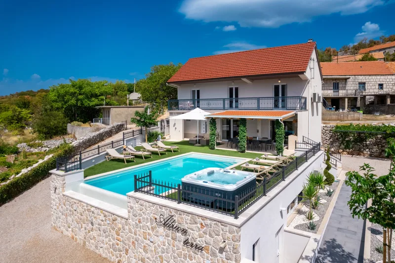 Villa facade, covered terrace, pool and Jacuzzi viewed from above