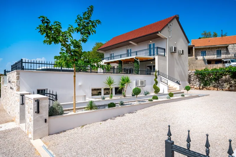 Villa entrance and private parking approach