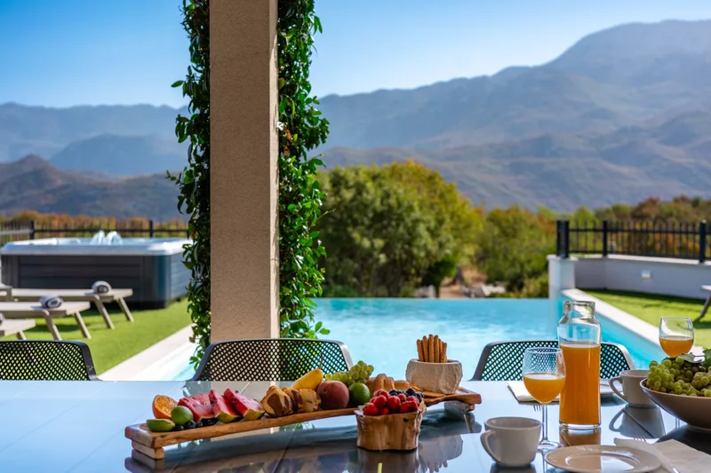 Breakfast on the covered terrace overlooking the pool and mountains