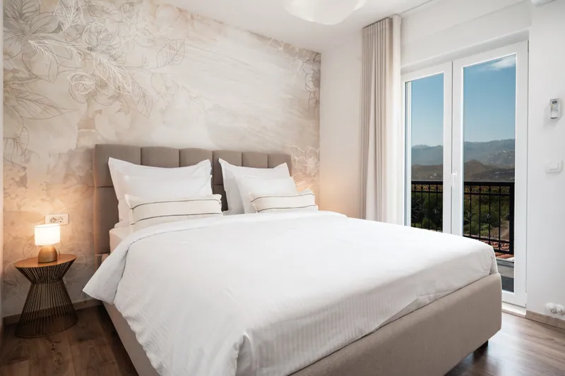 Bright king bedroom with balcony access