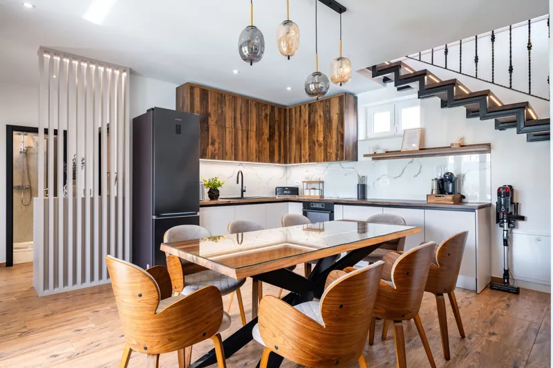 Kitchen and dining table beneath the open staircase