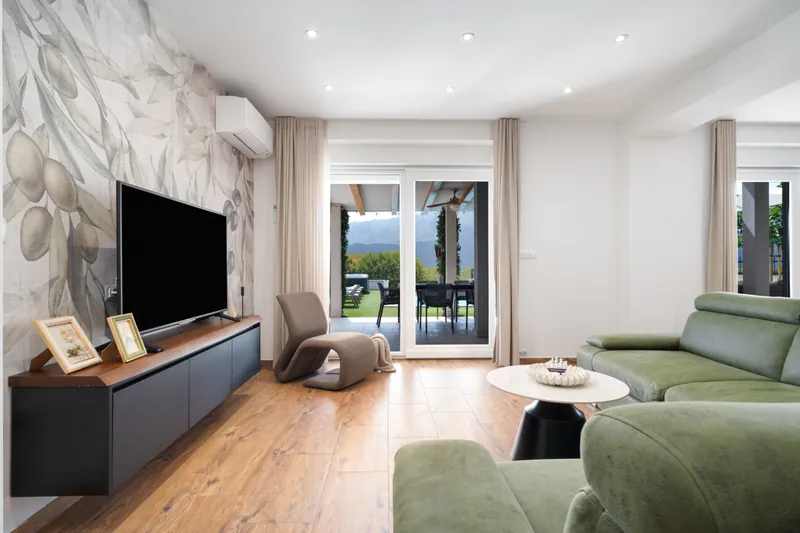 Open-plan living room and doors to the terrace