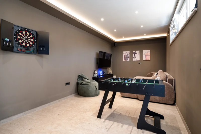 Game room with table football, darts, beanbags and a sofa