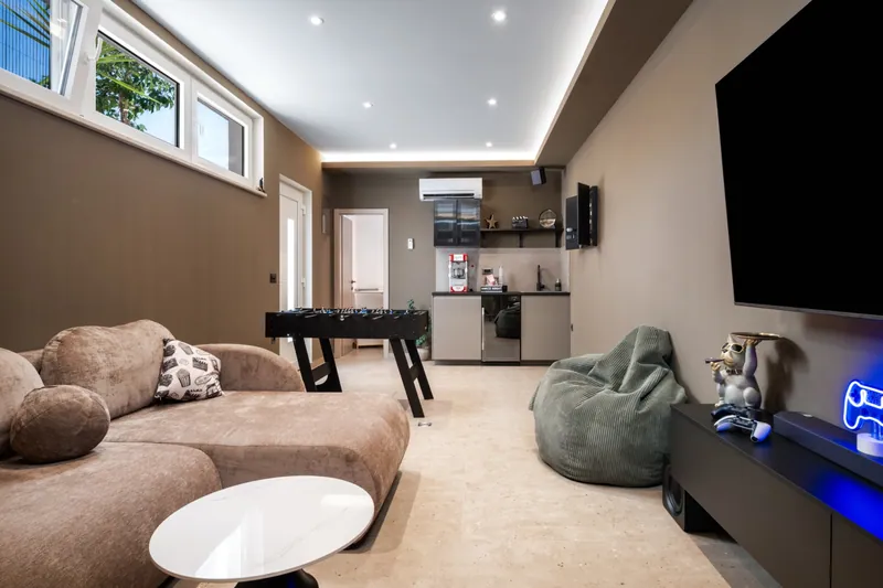 Separate game room with seating and table football