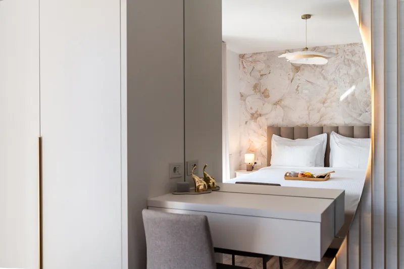 Bedroom dressing table and mirror reflecting the double bed