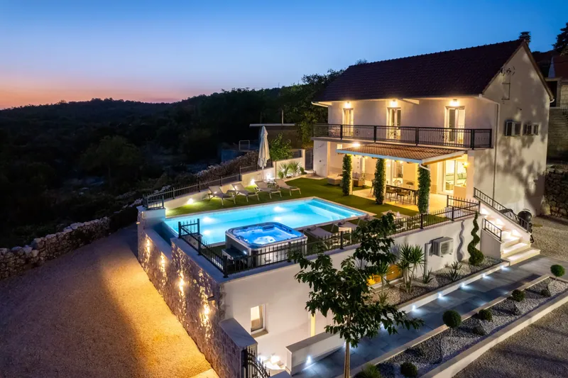 Villa exterior and pool at blue hour