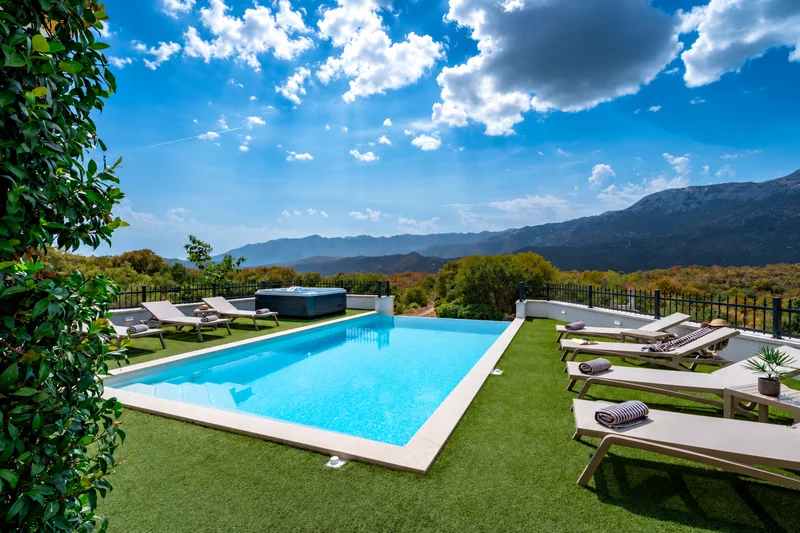 Private pool surrounded by loungers and mountain views